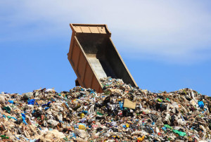 unloading truck in a mountain of trash